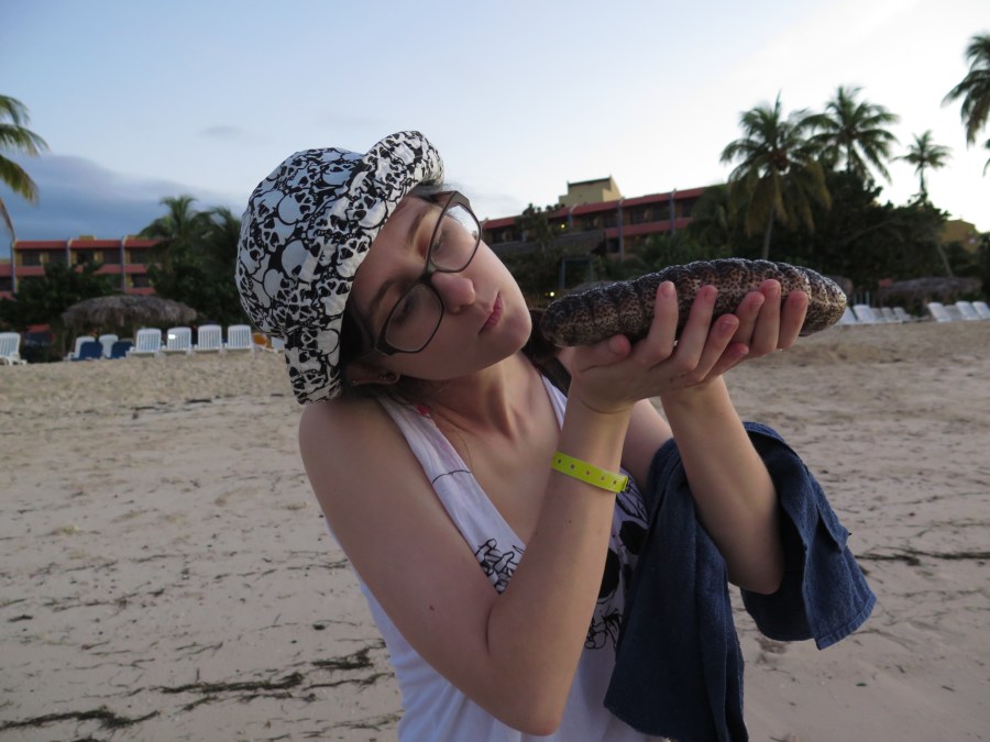 Sarah contemplating whether to kiss a sea cucumber