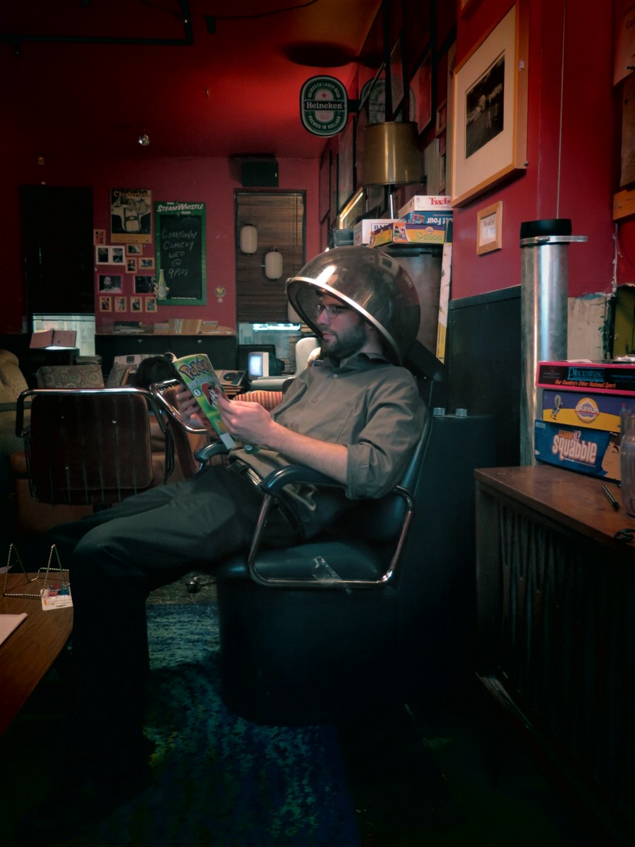 Devin reading a Pokemon Comic before guests arrive.