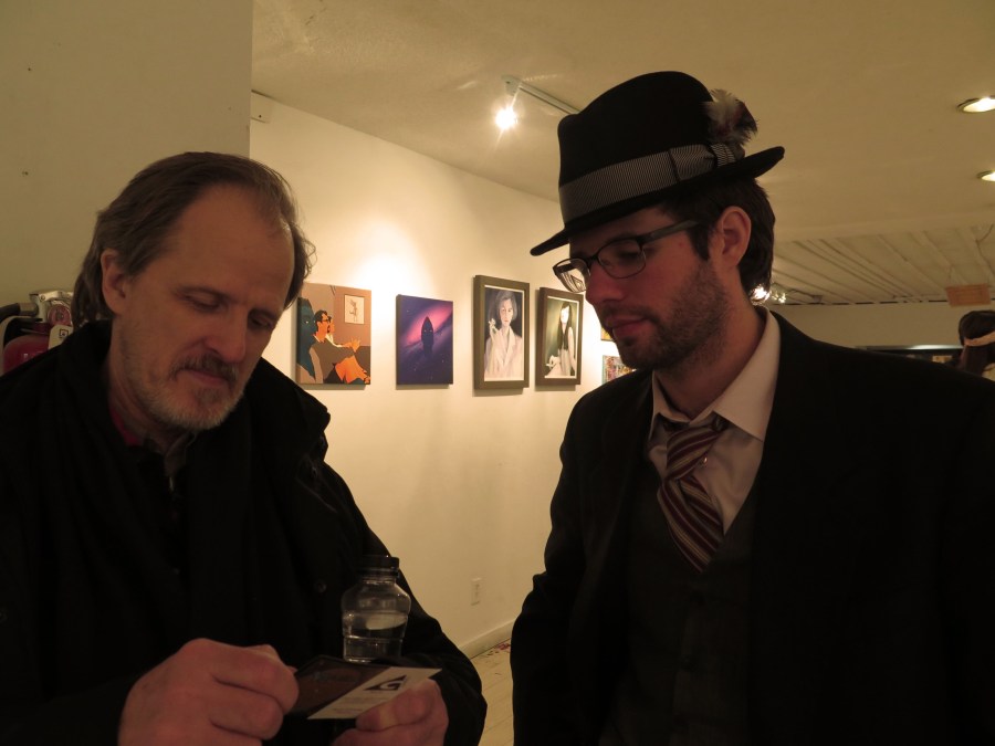 Devin showing my father his Geek Collateral business cards.